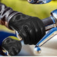 Black leather glove with intricate design on a motorcycle handlebar