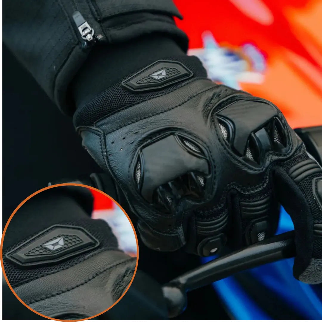 Black motorcycle glove with brand logo on a blurred background